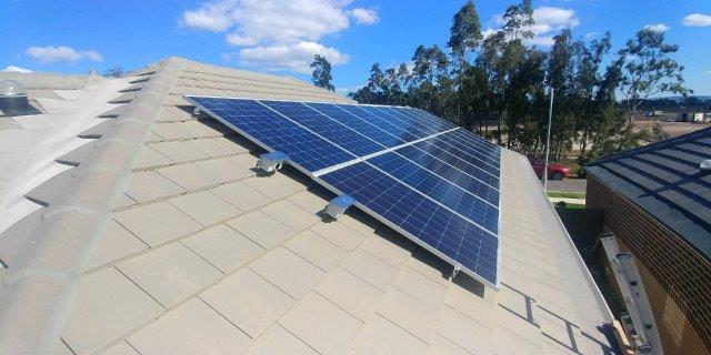 solar panels on house roof under blue sky